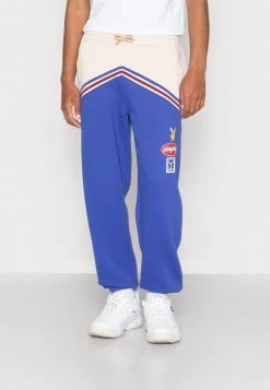 Budget 🛒 Mennace PLAYBOY BADGE PANEL REGULAR JOGGER UNISEX - Jogginghose - Blue 🎁